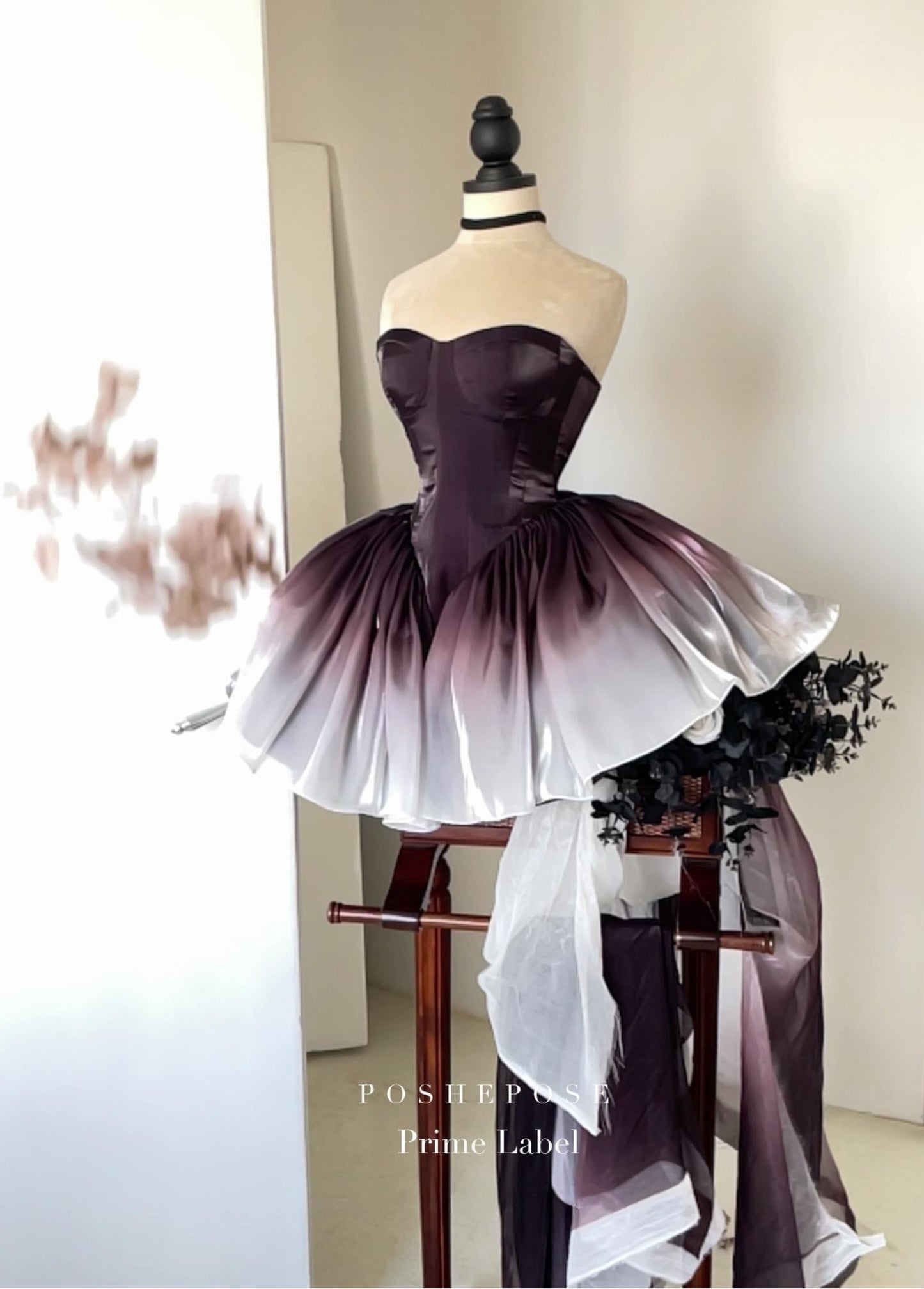 PoshePose Black Swan dress with gradient skirt and structured corset bodice.