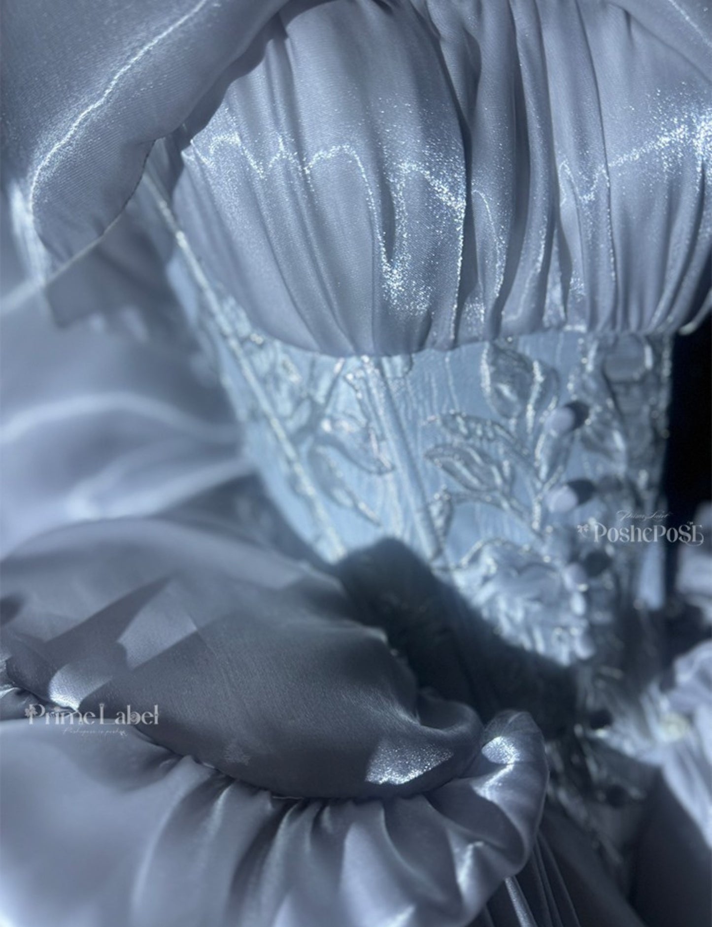 Elegant silver gown with oversized bow and cascading ruffles