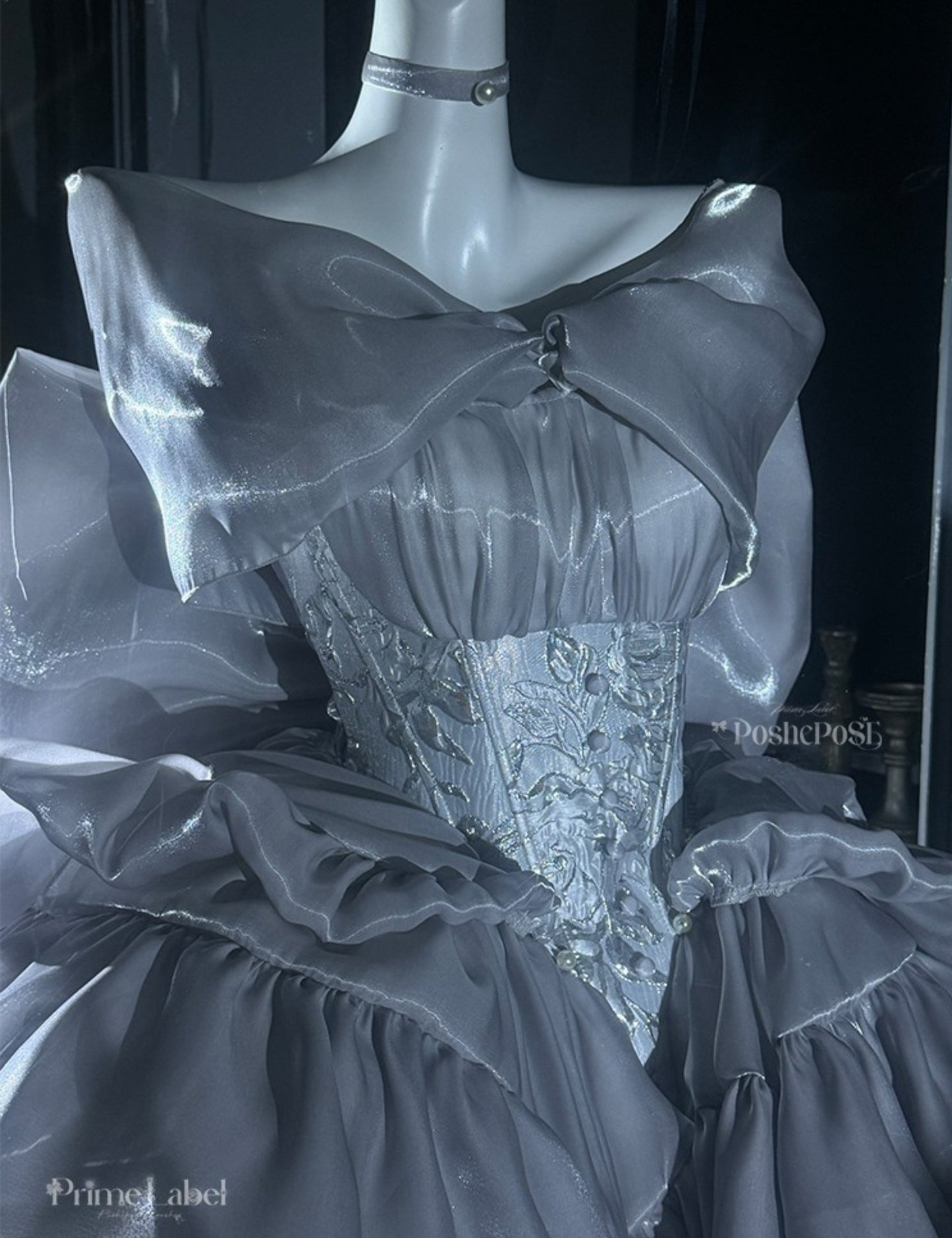 Vintage-inspired silver couture dress with structured shape