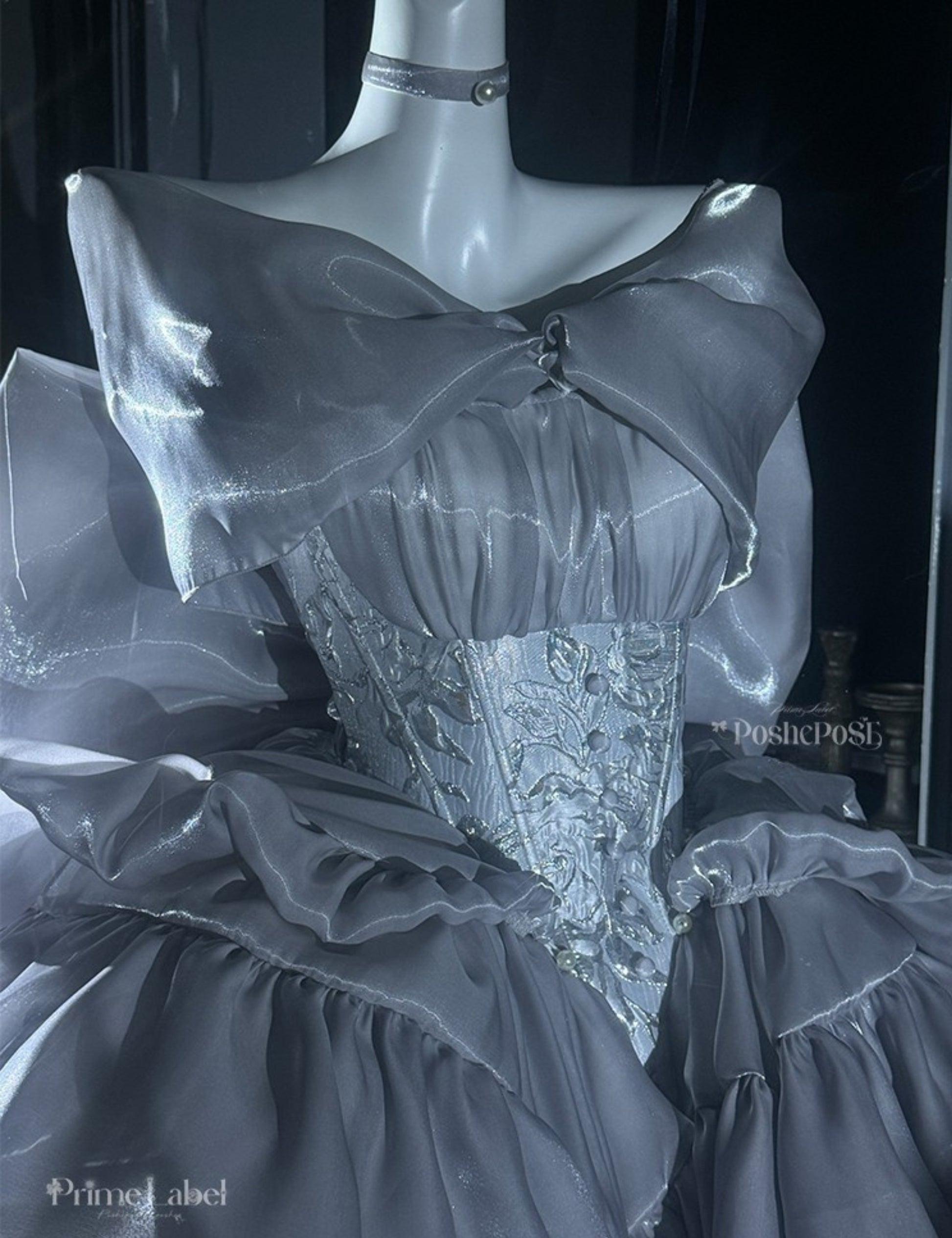 Vintage-inspired silver couture dress with structured shape