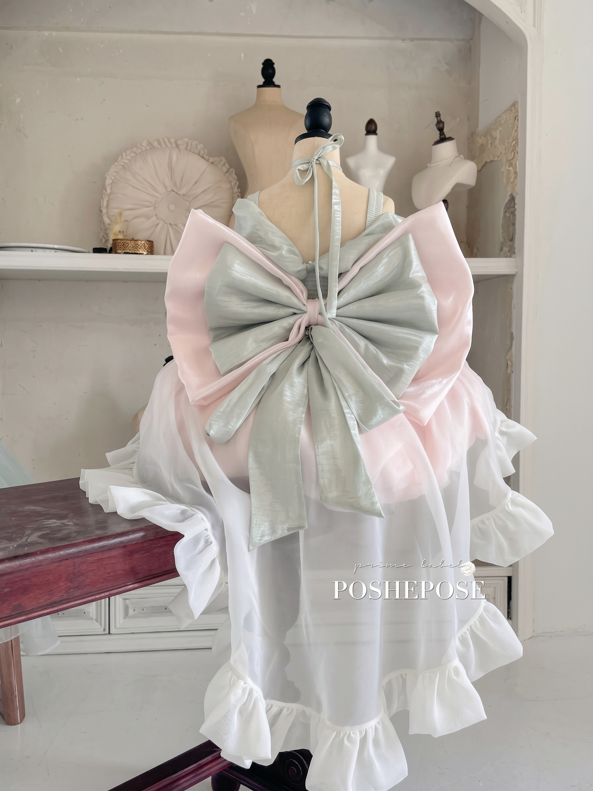 Close-up of the Cherry Tea Princess Dress bodice with delicate ribbon bows and embellishments