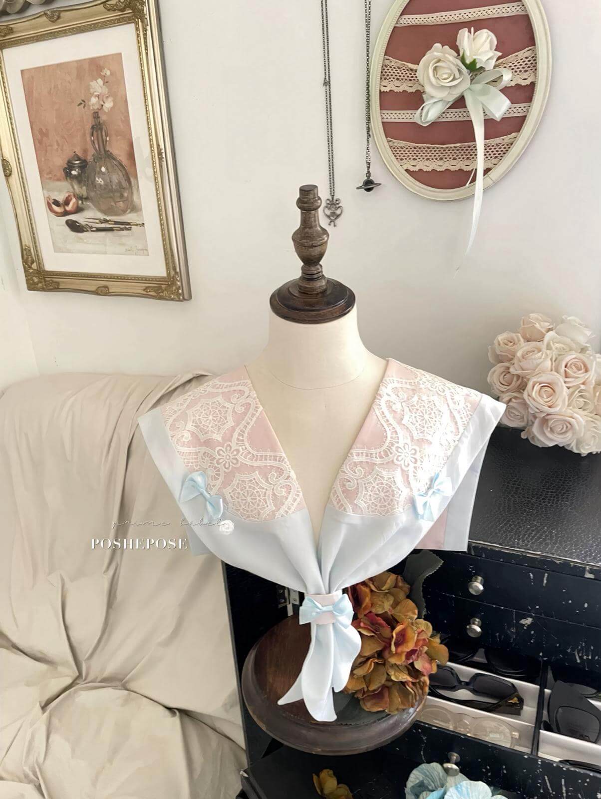 Delicate pink and blue vintage dress with lace collar and satin ribbons.