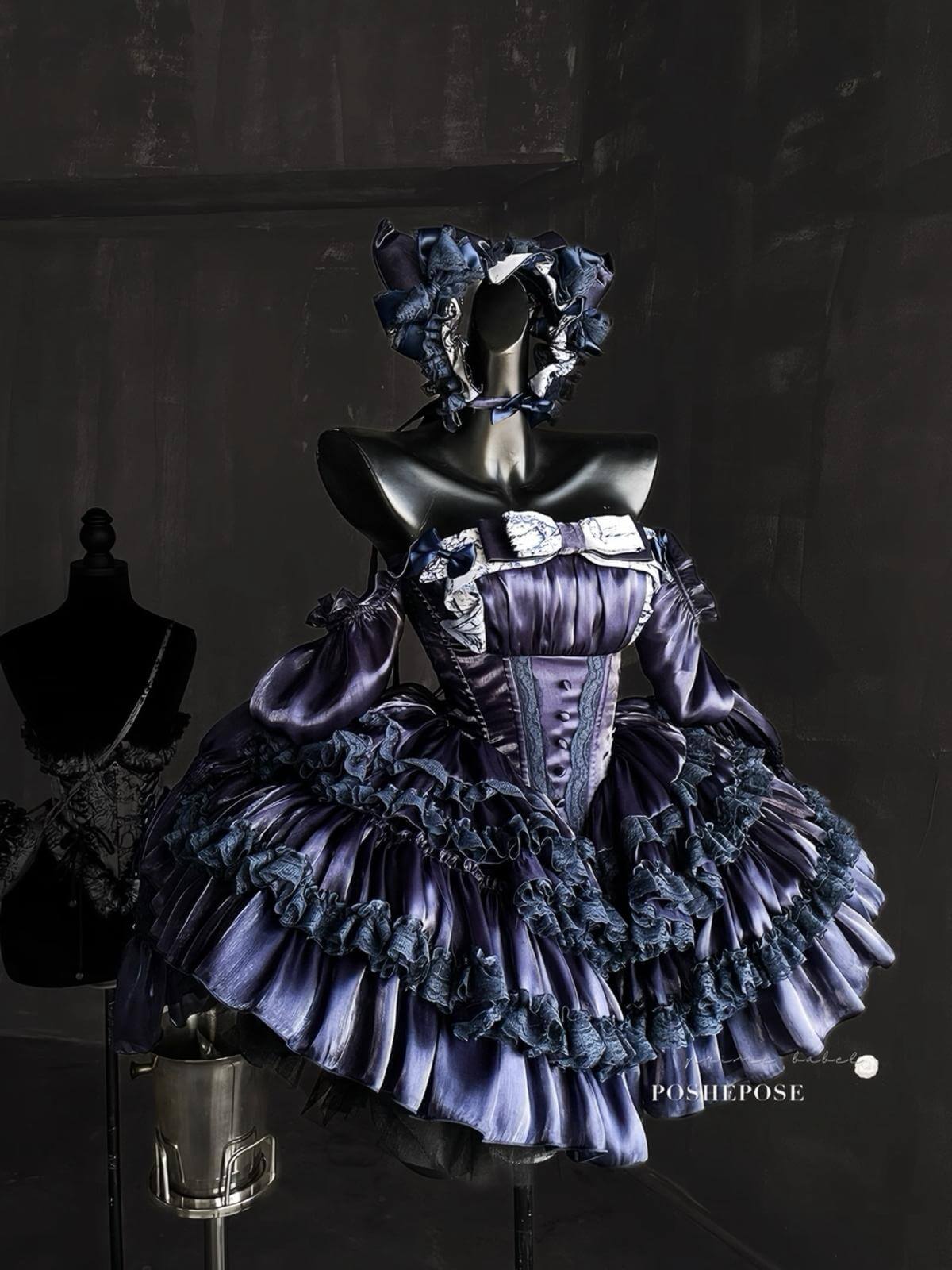 Victorian-inspired navy dress with puff sleeves and lace-up corset by Poshepose Global.