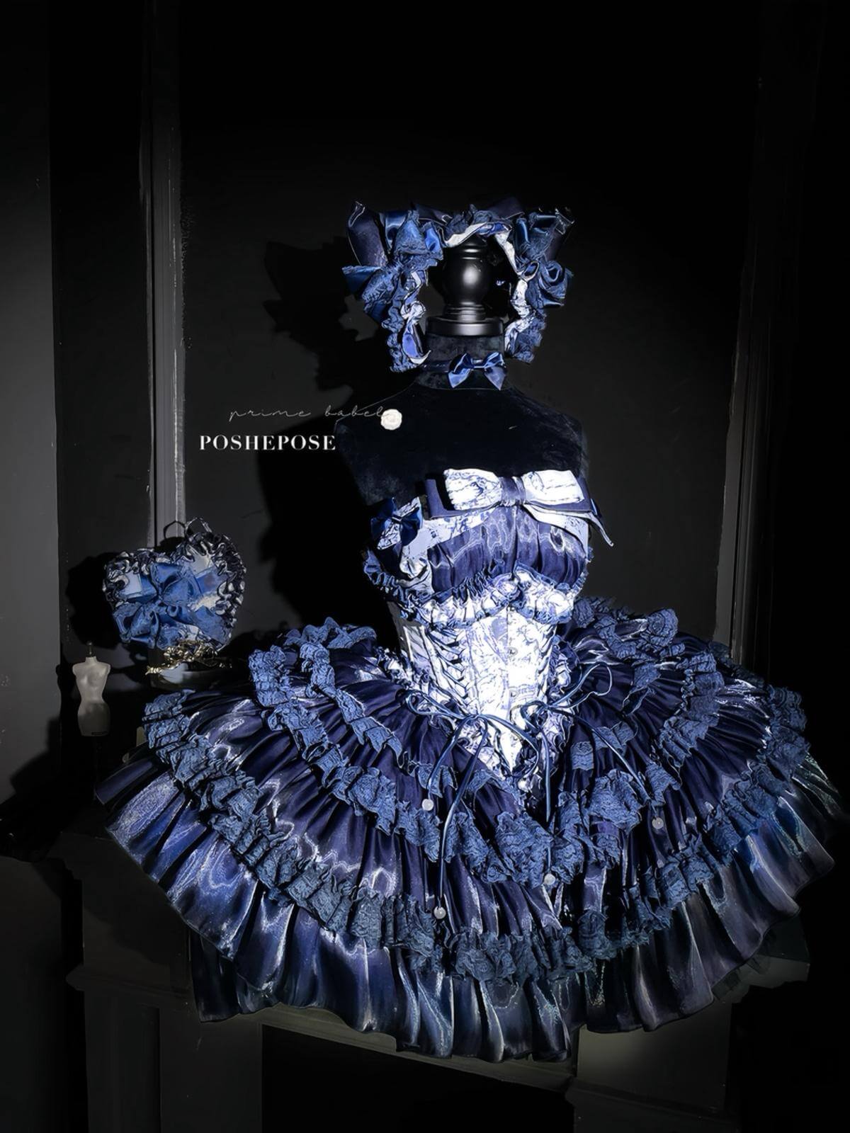 Elegant navy gothic lolita outfit featuring satin fabric and dramatic ruffled skirt.