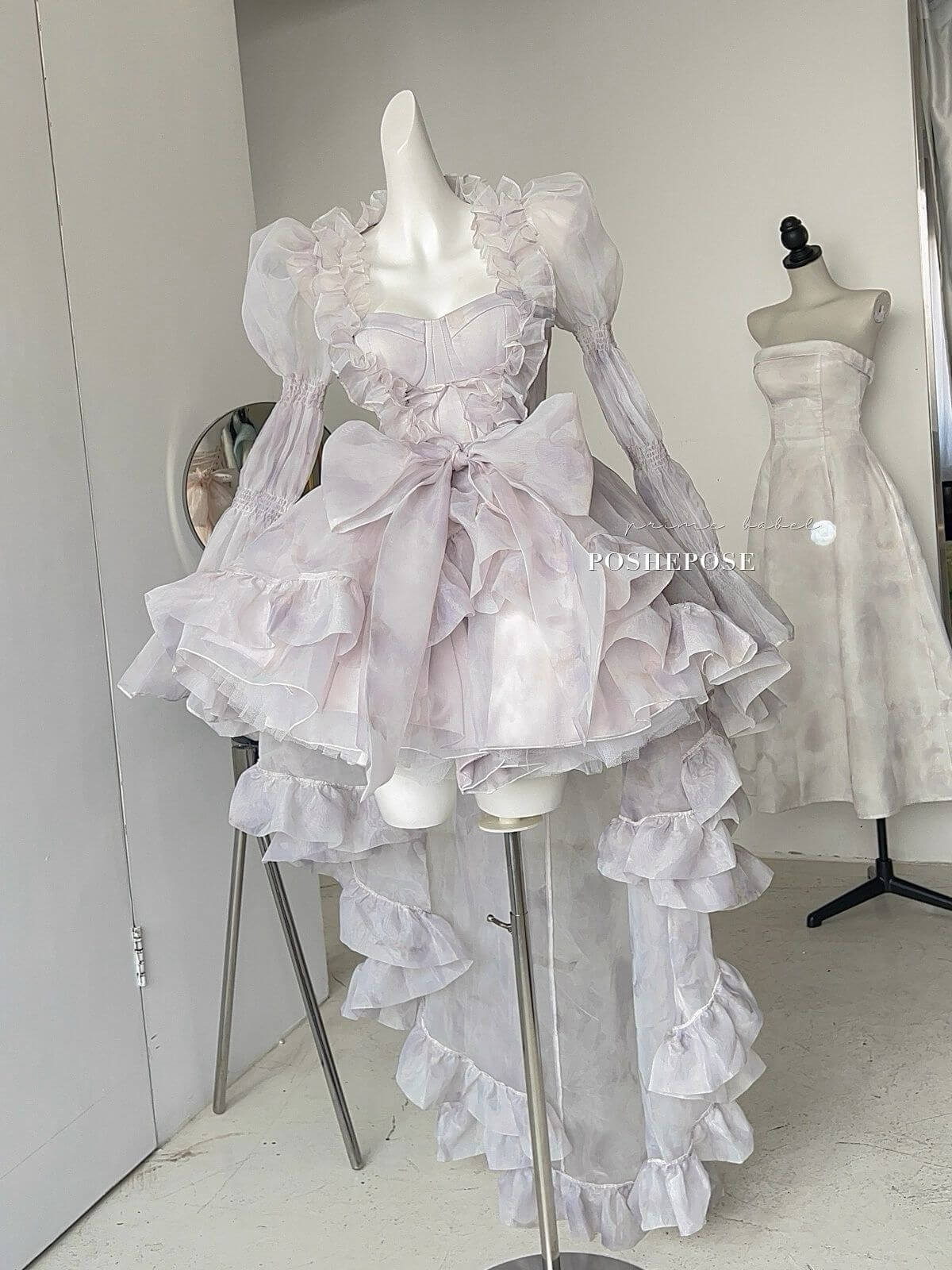 Elegant Rococo-style outer cape in soft purple tones with oversized bow details.