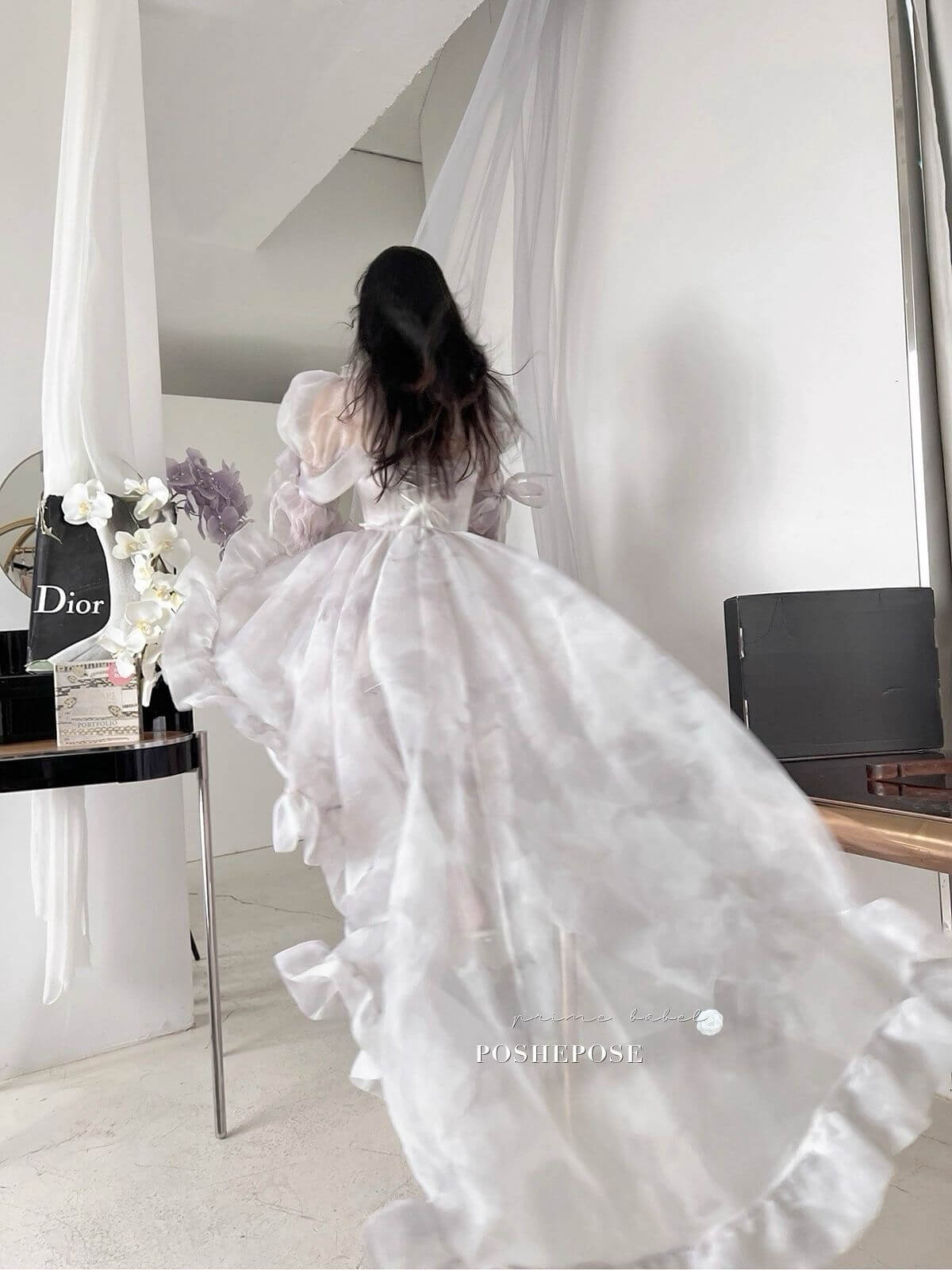 Sheer fairy dress in lilac organza with long train and layered frill hemline.