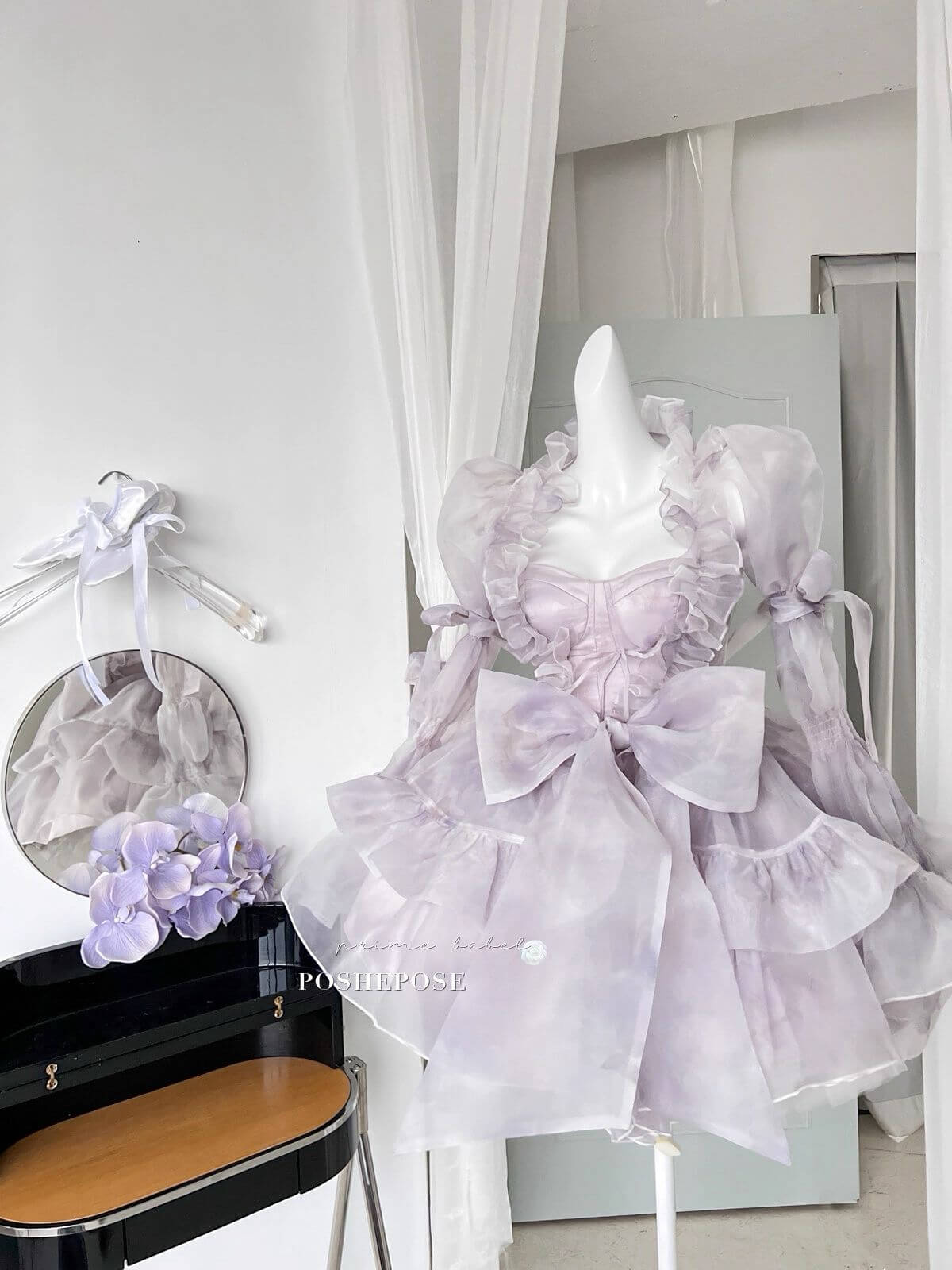 Poshepose Global Innocent Spirit Iris dress with puffed shoulders and flowing translucent cape.