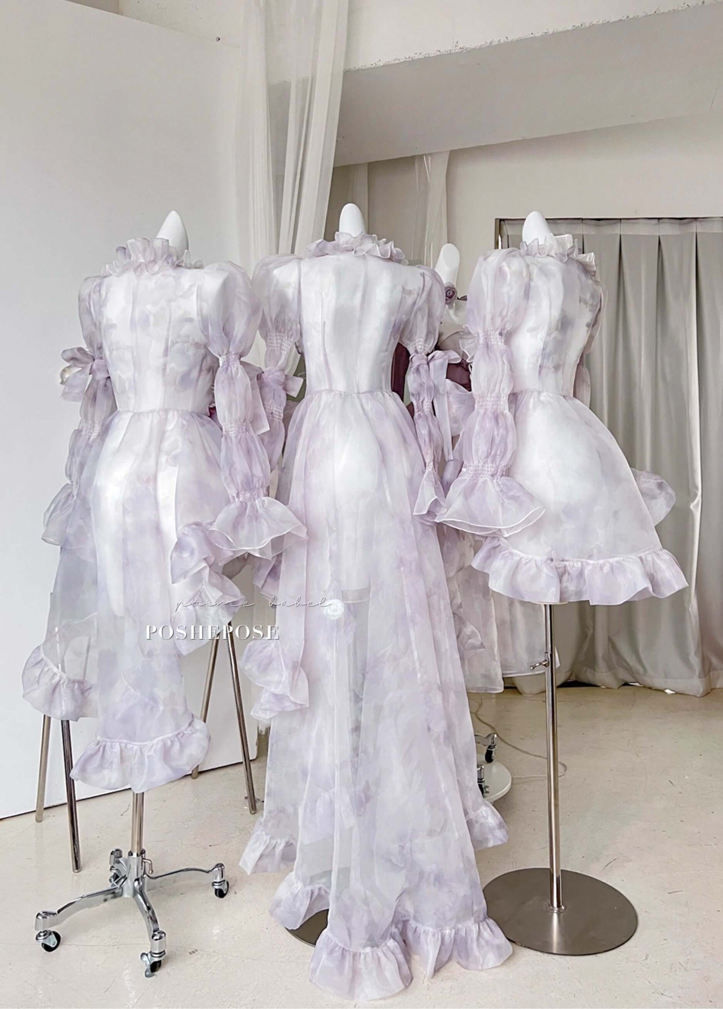 Romantic fairycore cape dress in soft lavender tones with oversized bow and cascading layers.