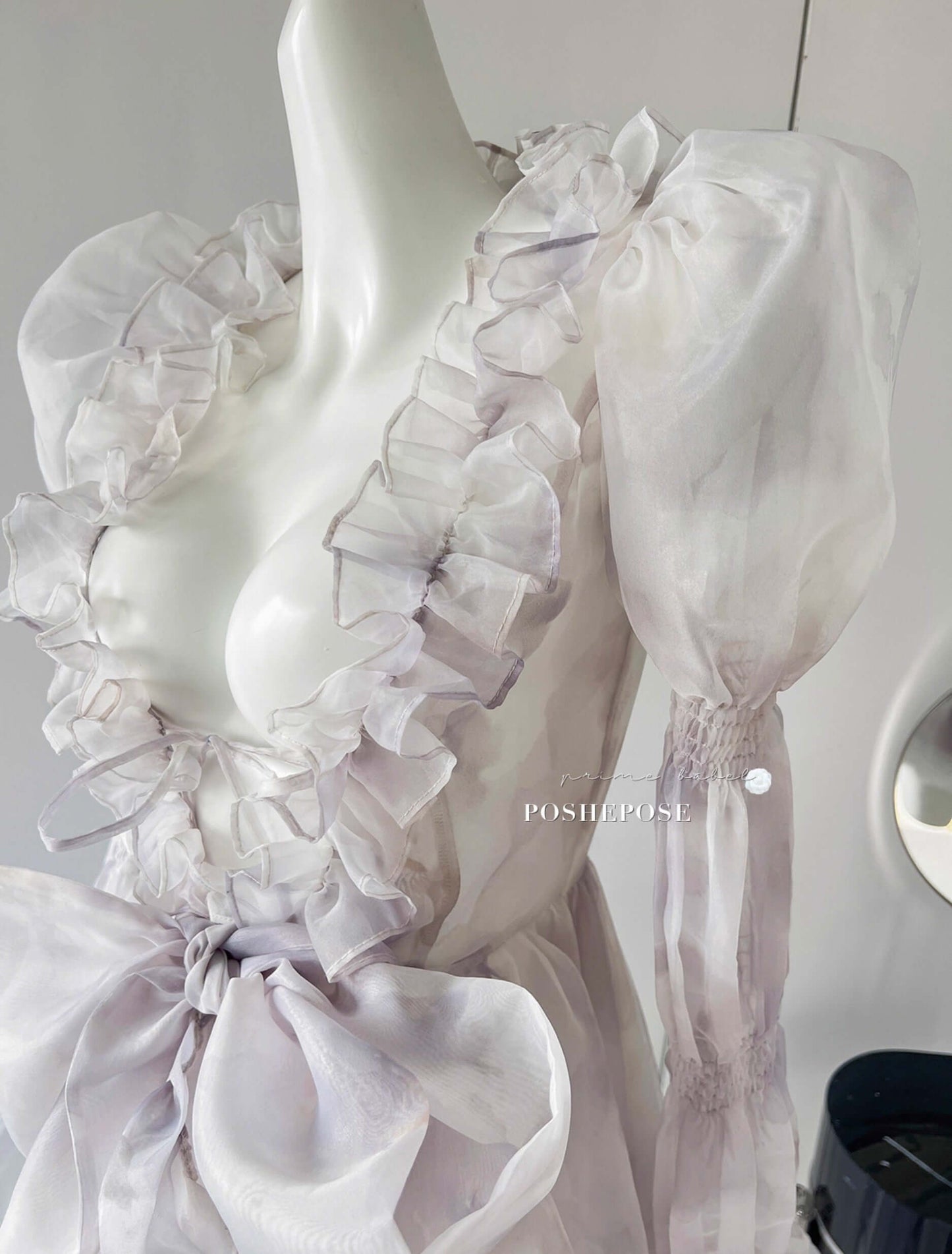 Couture fairy-tale gown in lavender organza with structured corset bodice.