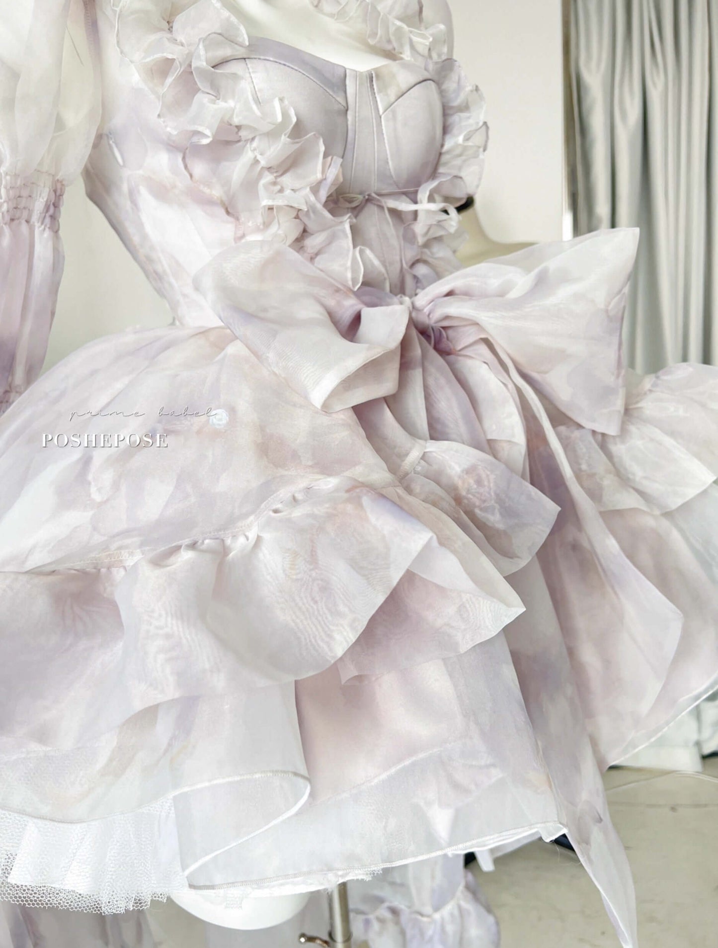 Romantic lilac lolita cape dress featuring long sheer sleeves and bow accent.