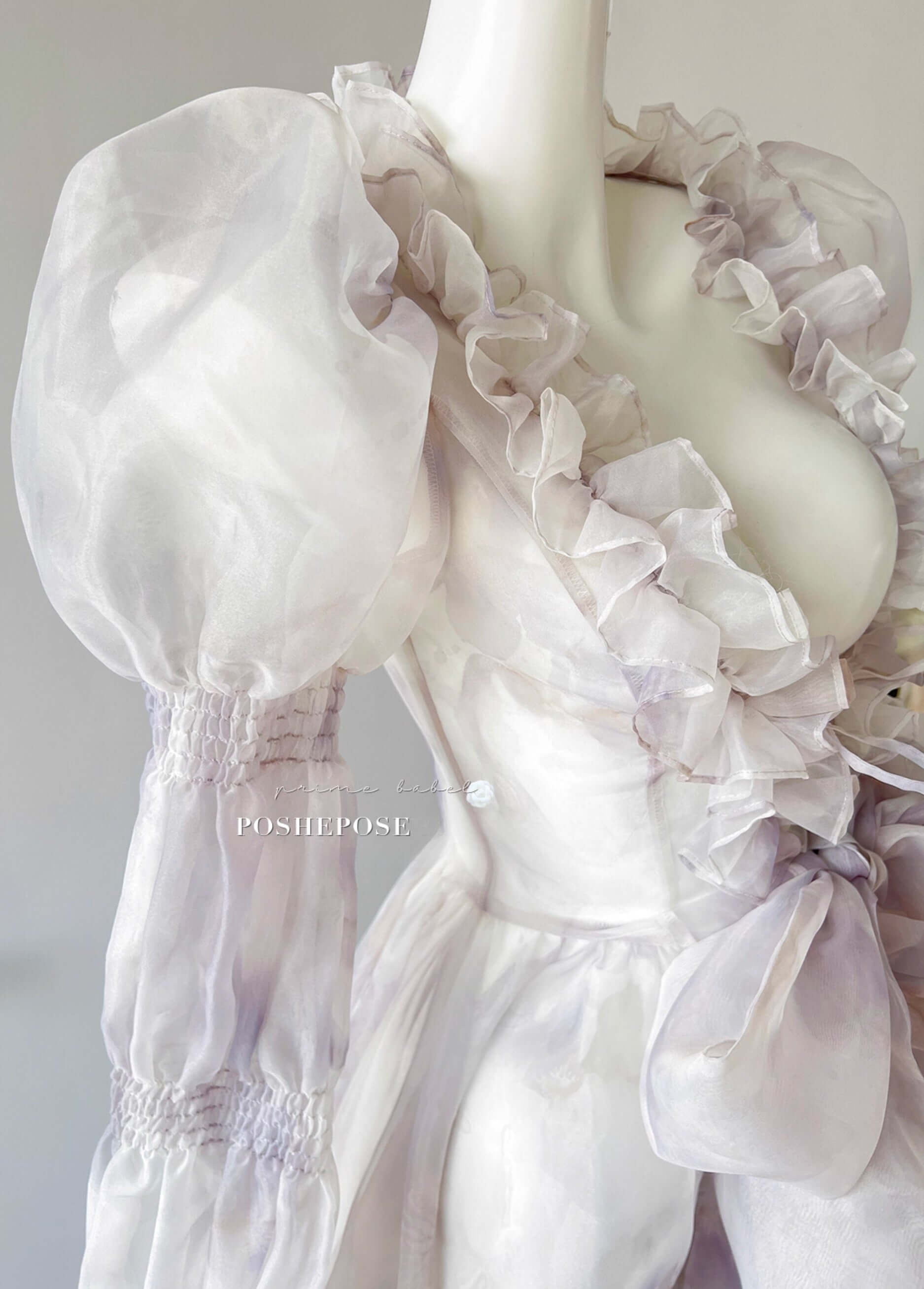 Sheer pastel lolita dress with high-low ruffle skirt and romantic puff sleeves.