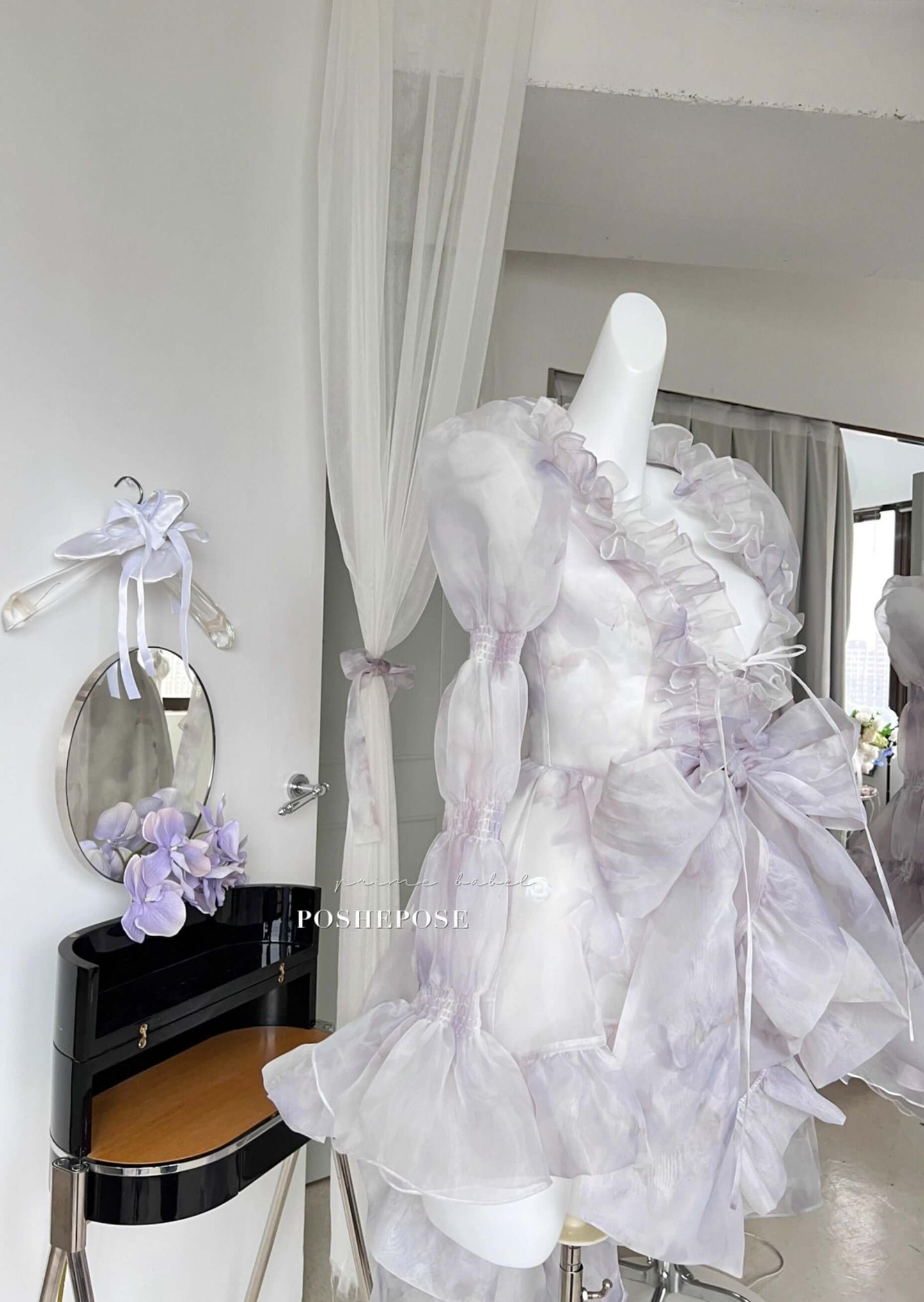 Victorian fairy dress in lilac organza with bow-tied waist and romantic cascading train.
