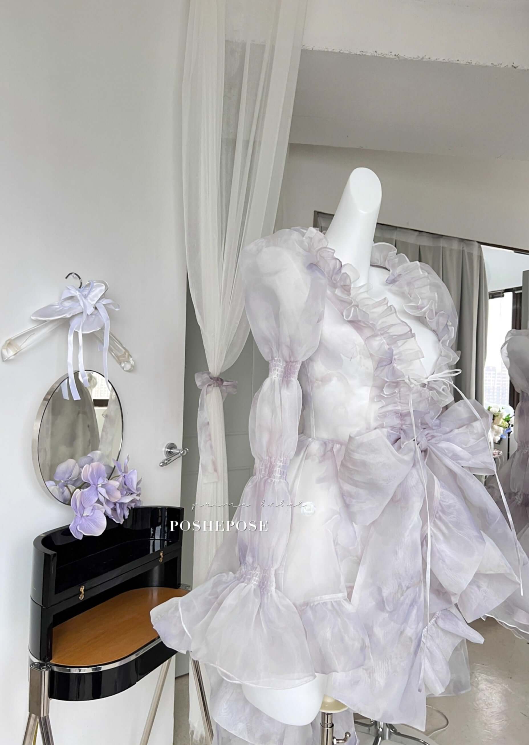 Victorian fairy dress in lilac organza with bow-tied waist and romantic cascading train.