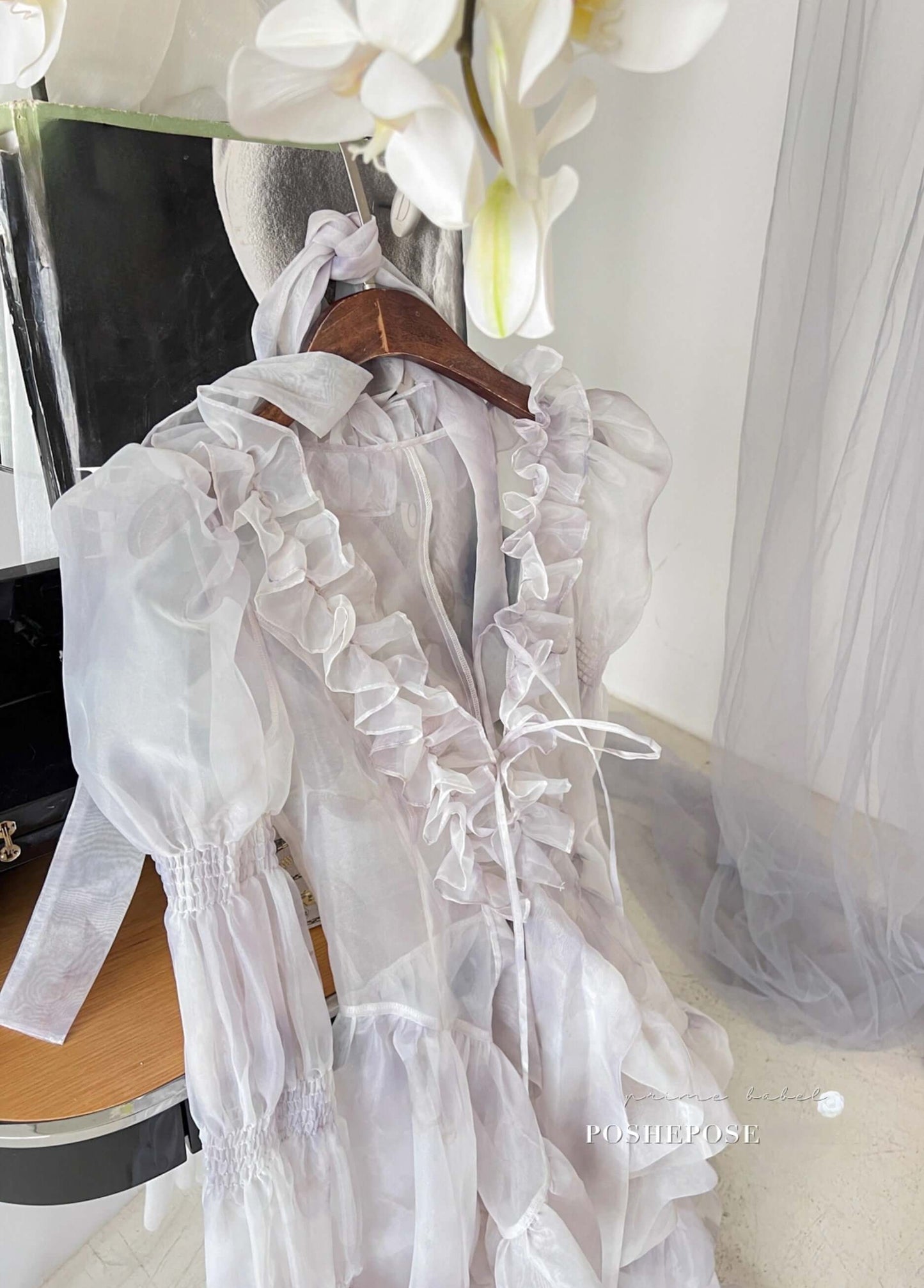 Fairy-inspired Rococo gown with ruffled organza layers and oversized bow.