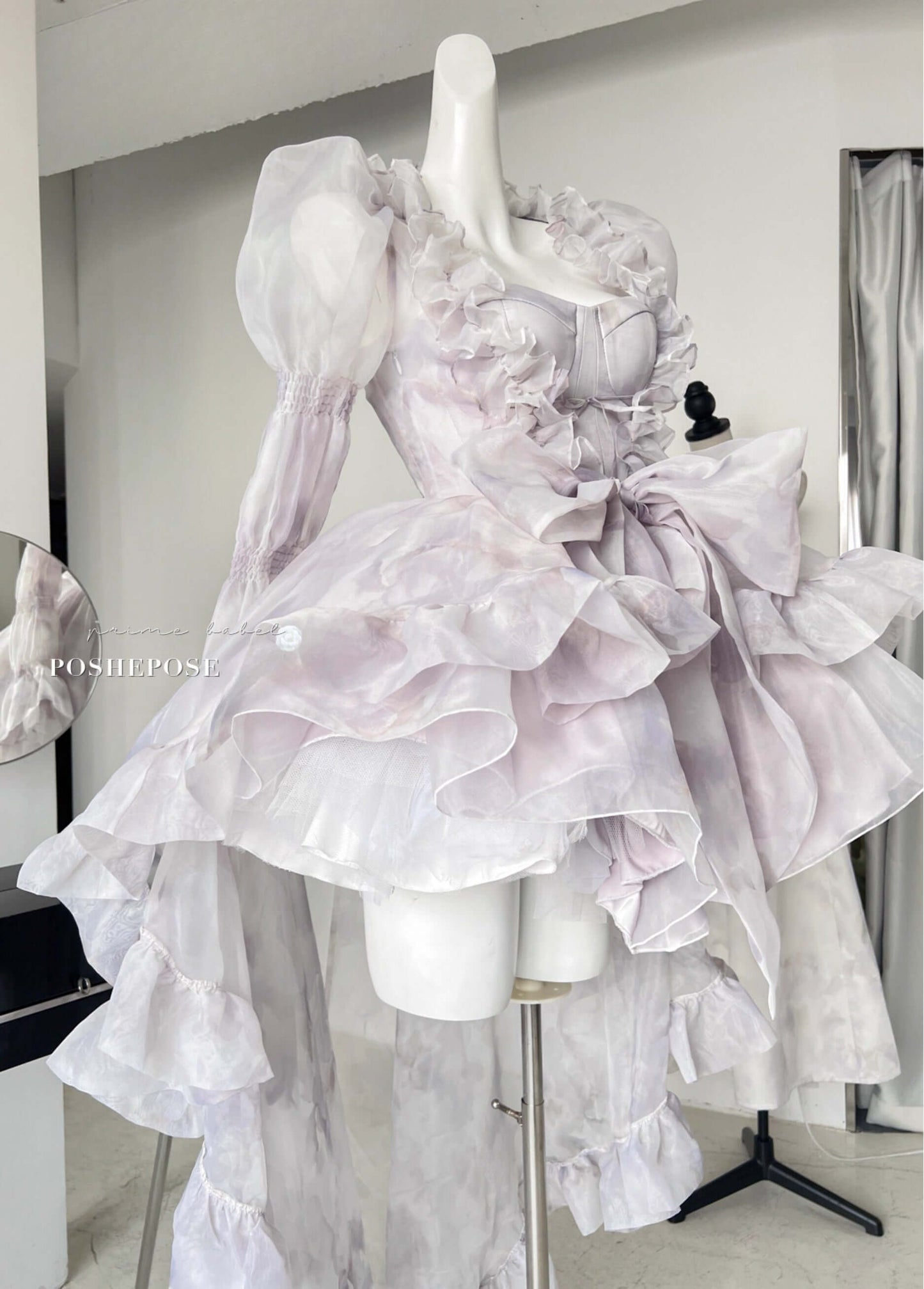 Pastel lolita gown with ruffled outer cape and soft chiffon bow by Poshepose Global.