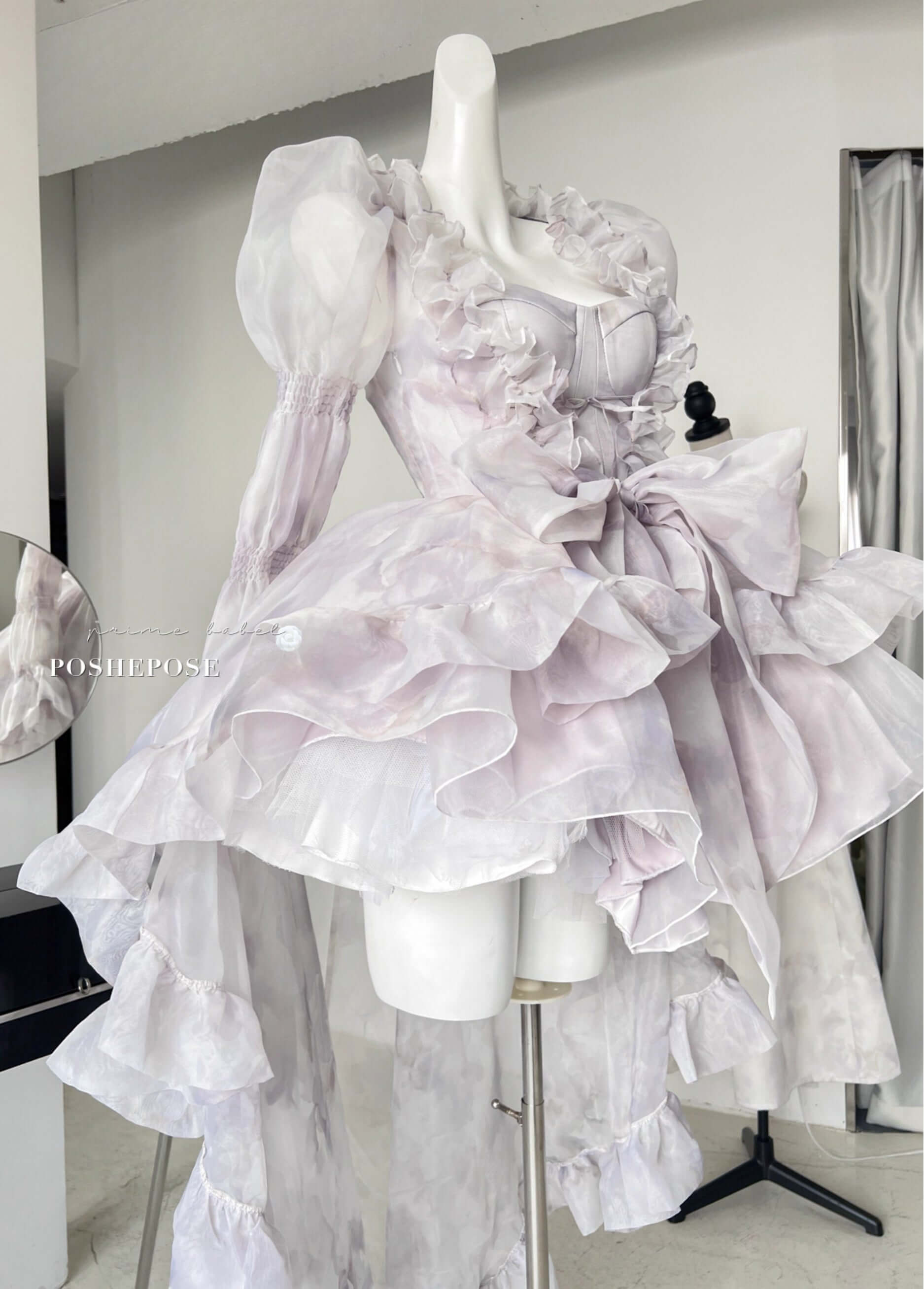 Pastel lolita gown with ruffled outer cape and soft chiffon bow by Poshepose Global.