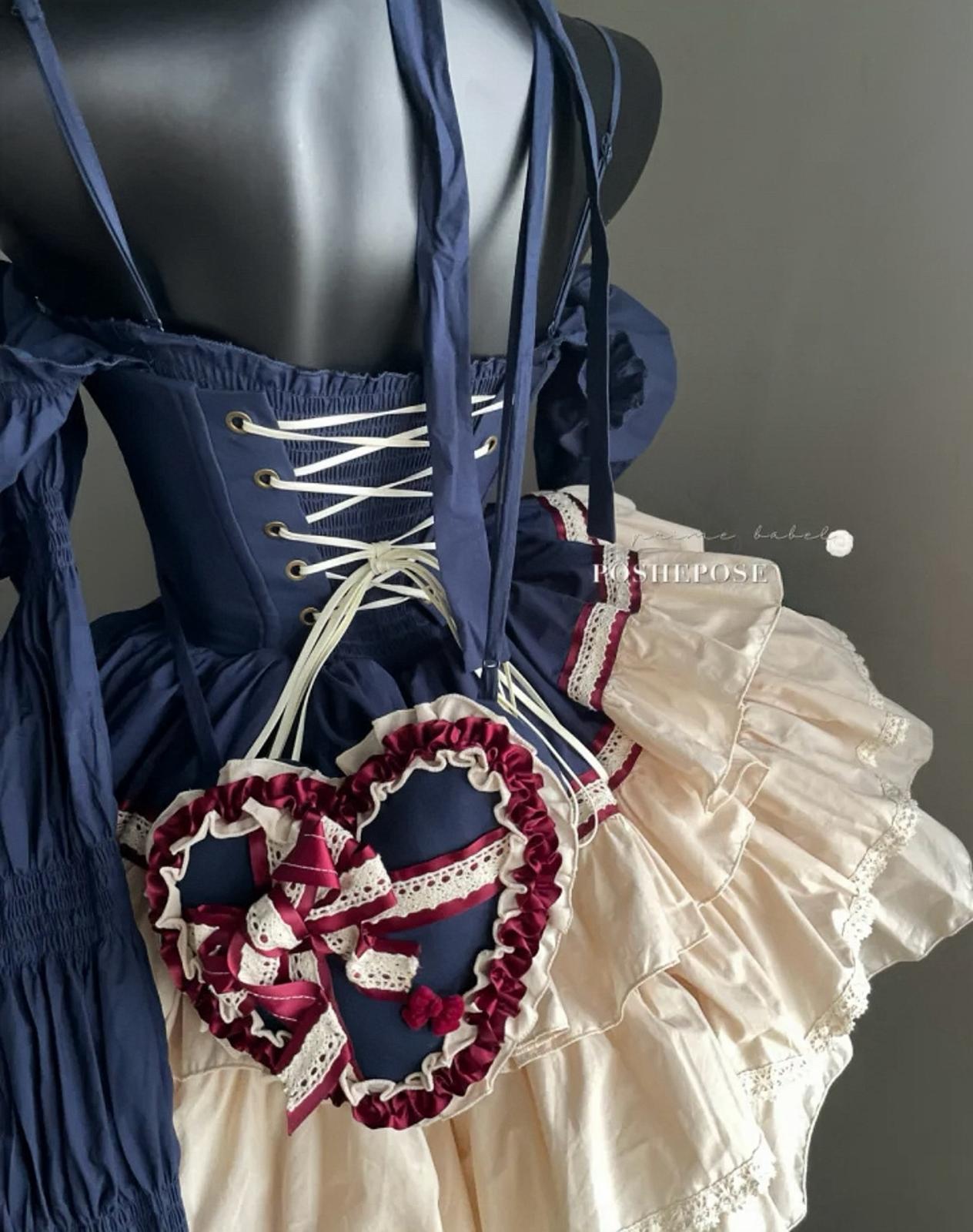 Elegant Rococo-style heart dress with navy corset and frilled hemline by Poshepose.