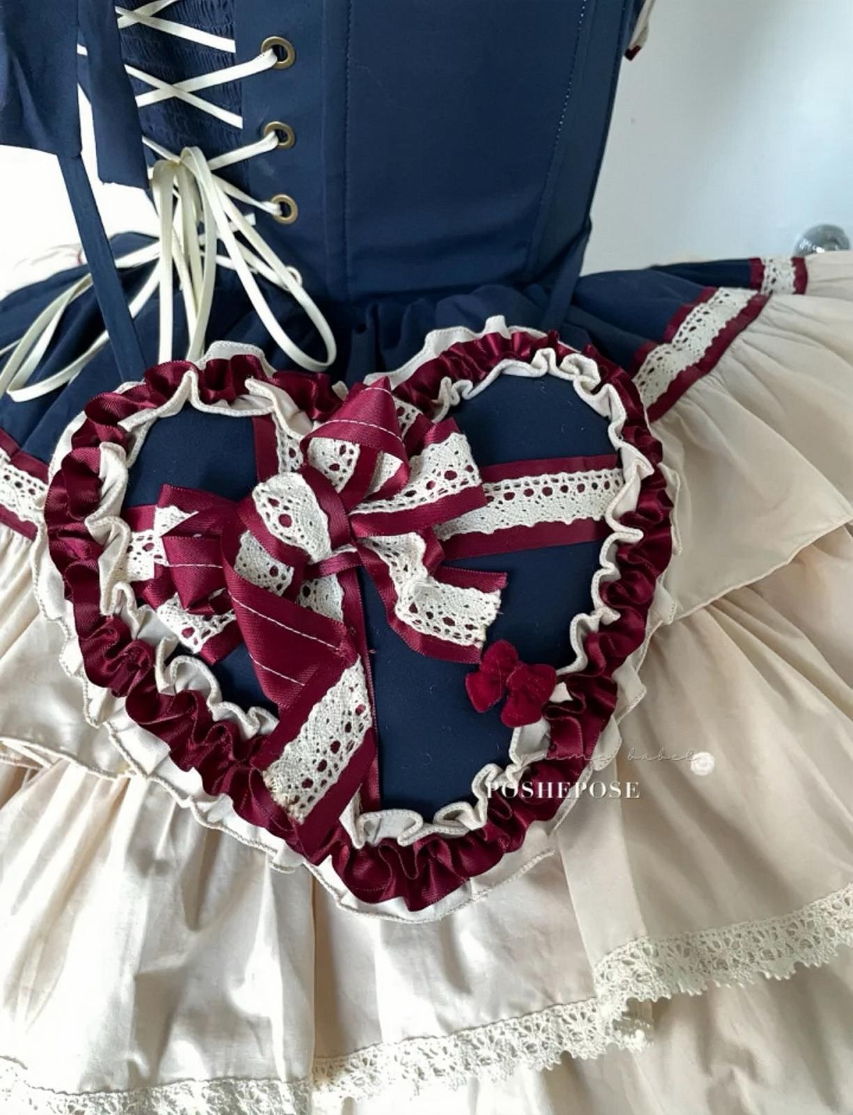 Fairytale-inspired lolita outfit in cream and navy tones with romantic heart bag.