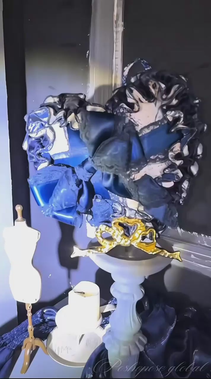 Baroque-inspired navy corset dress with puff sleeves and ruffled underskirt.